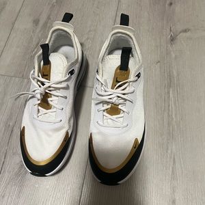Nikes white black and gold